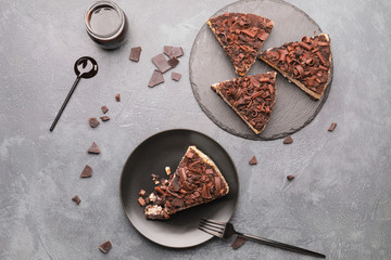 Pieces of tasty chocolate cheesecake on table
