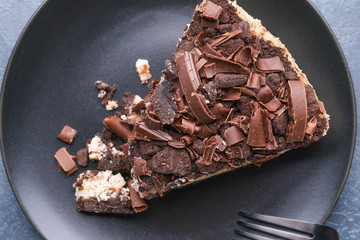 Plate with piece of tasty chocolate cheesecake on table, closeup