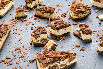 Pieces of tasty chocolate cheesecake on color background
