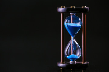 Hourglass on dark background. Time management concept