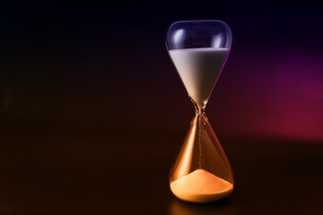 Hourglass on dark background. Time management concept