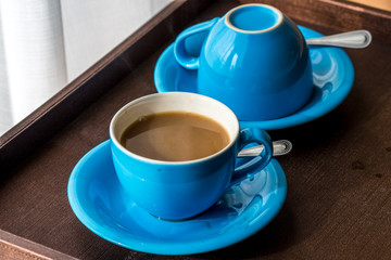 Blurred background view of a mug or coffee cup, a cup of water or a drink on the table, for customer service in a room or restaurant