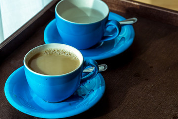 Blurred background view of a mug or coffee cup, a cup of water or a drink on the table, for customer service in a room or restaurant