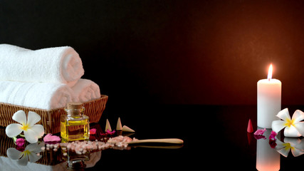 Close up view of spa treatment and relax concept with white towel, candle and aroma oil
