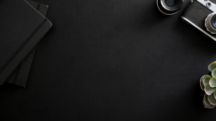 Top view of photographer workplace with copy space, camera, office supplies and decorations