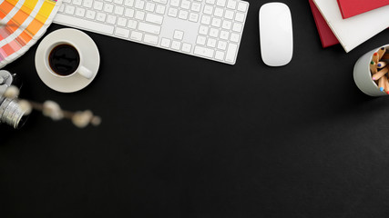 Top view of designer workspace with office supplies on black table background and copy space 