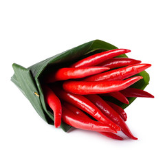 Red chili peppers Wrapped in banana leaves isolated on a white background