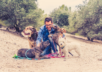 Professional dog walker having fun and caring for his customers a pack of cute dogs