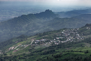 Naklejka premium Road curve on mountain and village, Aerial View.