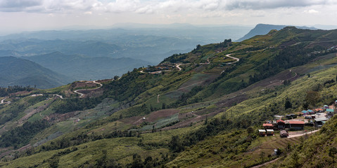 Fototapeta na wymiar Road curve on mountain and village, Aerial View.