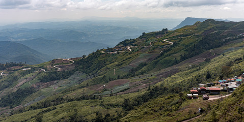 Road curve on mountain and village, Aerial View.