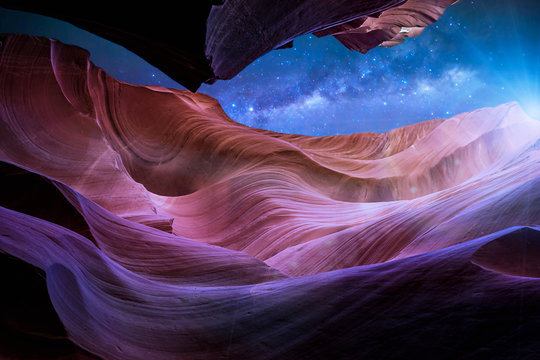 Antelope Canyon's red rock formations under a midnight blue evening sky in Page, Arizona, USA.