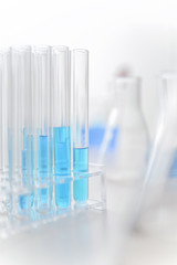 Glassware in a chemical laboratory, test tube, erlenmeyer flask with blue chemical liquid.