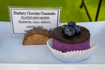 Blueberry chocolate cheesecake at a homemade food stand at the local farmer's market. Glossy...