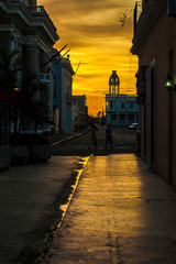 Street at sunset. Location: Cienfuegos City, Cuba. 
View of Cienfuegos' street at sunset. 