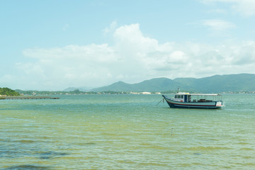 Beautiful lake landscape with an anchored fishing boat.