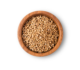 Dried coriander seeds top view on white background