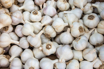 Natural patterns: super close up shot of many heads of fresh garlic at the farmer's market. Real,...
