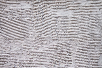 ribbed trowel markings and pattern on cement textured ready for adding adhesives and marble or tiles