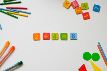 Math concept: colorful pens and pencils, number, calculating sticks in white background