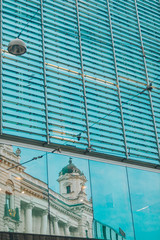 reflection of old building in glass window
