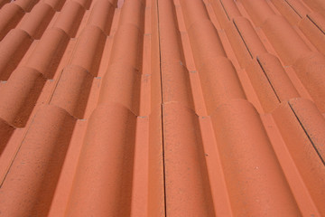 Rooftop pattern, arranged orange roof tiles, full frame, house covering