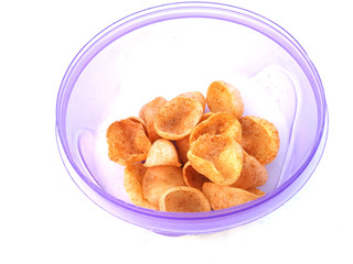 some yellow eatable food put in blue plastic bowl isolated on white background