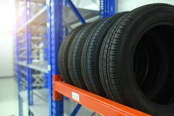 Large modern warehouse with forklifts and stack of car tires © sirisakboakaew