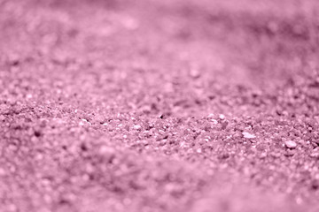 Coastal sand texture close-up. Natural background pink color toned