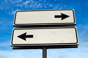 Crossroads Road Sign, Two Arrow on blue sky background, Isolated. Two way blank road sign with copy space. Two arrows on a pole pointing in different directions