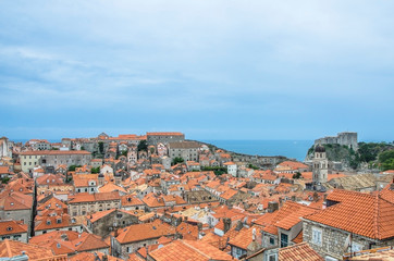Fototapeta na wymiar View of red rooftops and blue sea from Dubrovnik city wall, Dubrovnik, Croatia. View from above of old town center.