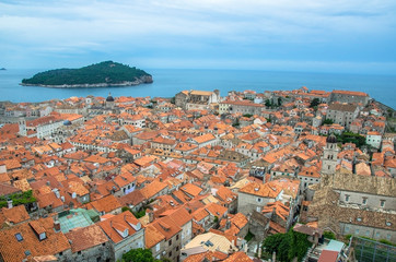 Fototapeta na wymiar View of red rooftops and blue sea from Dubrovnik city wall, Dubrovnik, Croatia. View from above of old town center.
