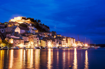 Illuminated harbor in Sibenik, Croatia. Sibenik at night, view on St. Michael's Fortress, Croatia. View of city in Adriatic coast of Croatia during blue hour. City illuminated at the evening.