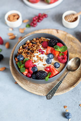 granola with yogurt and fresh berries in a bowl