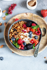 granola with yogurt and fresh berries in a bowl