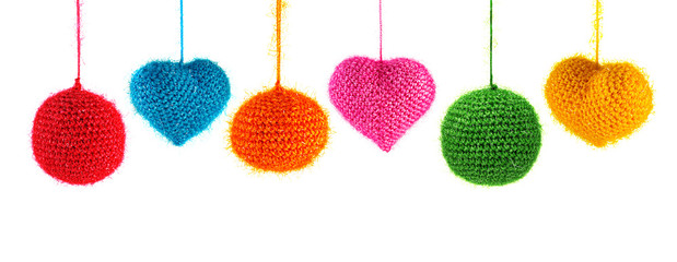Set of beautiful knitted hearts and balls, christmas toy hanging isolated on white
