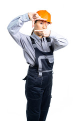 Girl in a construction helmet makes measurements with hand gestures. isolated