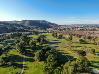 Obraz premium Aerial view of golf course with green field in the valley. Green turf scenery. Temecula, California, USA