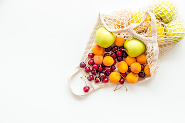 Eco-friendly package. Eco bag with fruits on white background top-down copy space