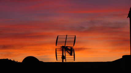 Television aeriel silhouette against golden Andalusian dawn