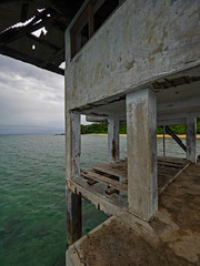 Fototapeta na wymiar dilapidated pier with the beach in the background