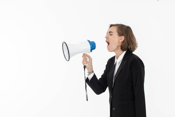 Young business woman is shouting through a megaphone on white isolated background.