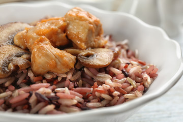 Delicious brown rice in bowl, closeup view