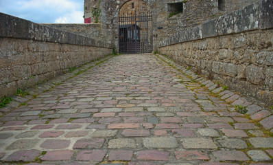 Stone pathway and gate into a fortress at Dinan, France
