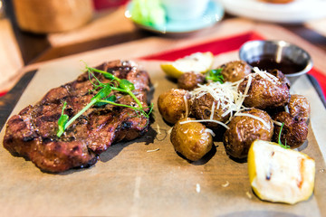 Appetizing pork neck with baked apple, potatoes and parmesan
