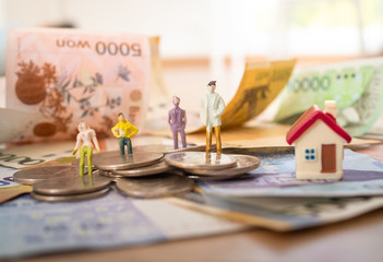 Korean banknotes with models in work clothes and Korean won coins for money concept background