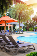 Deckchairs on beside swimming pool