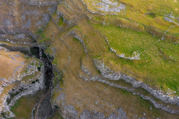 Drone shot show Gordale Beck a it travels through Gordale Scar, Malham, Yorkshire Dales National...