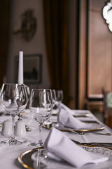 A glass on the table for wine. Interior of a classic restaurant in an old castle. Traveling in Europe. Served tables and antiquity.