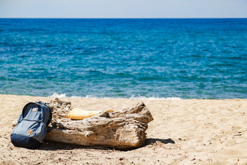 Fototapeta na wymiar Tourist rucksack on a sandy tropical beach.